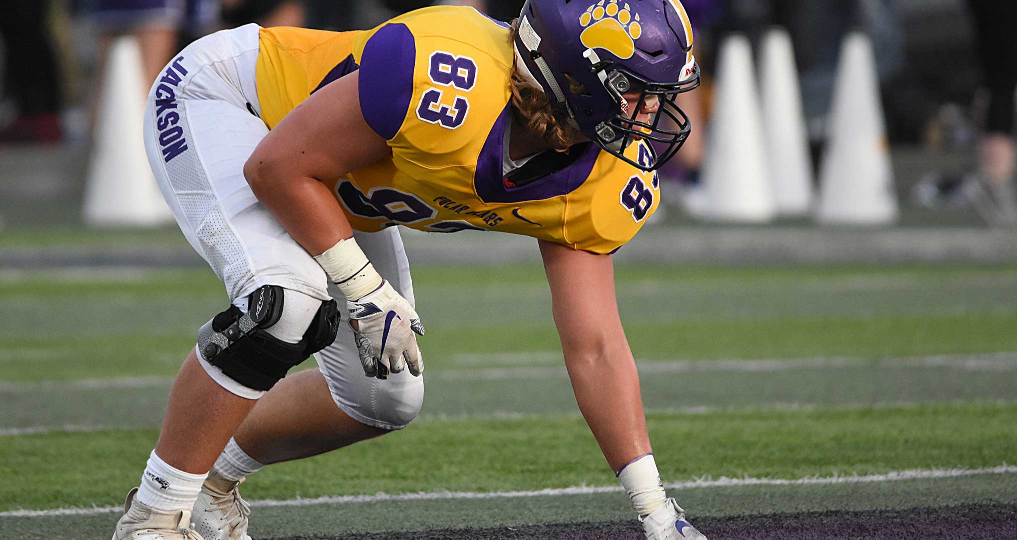 football player getting ready to run the ball