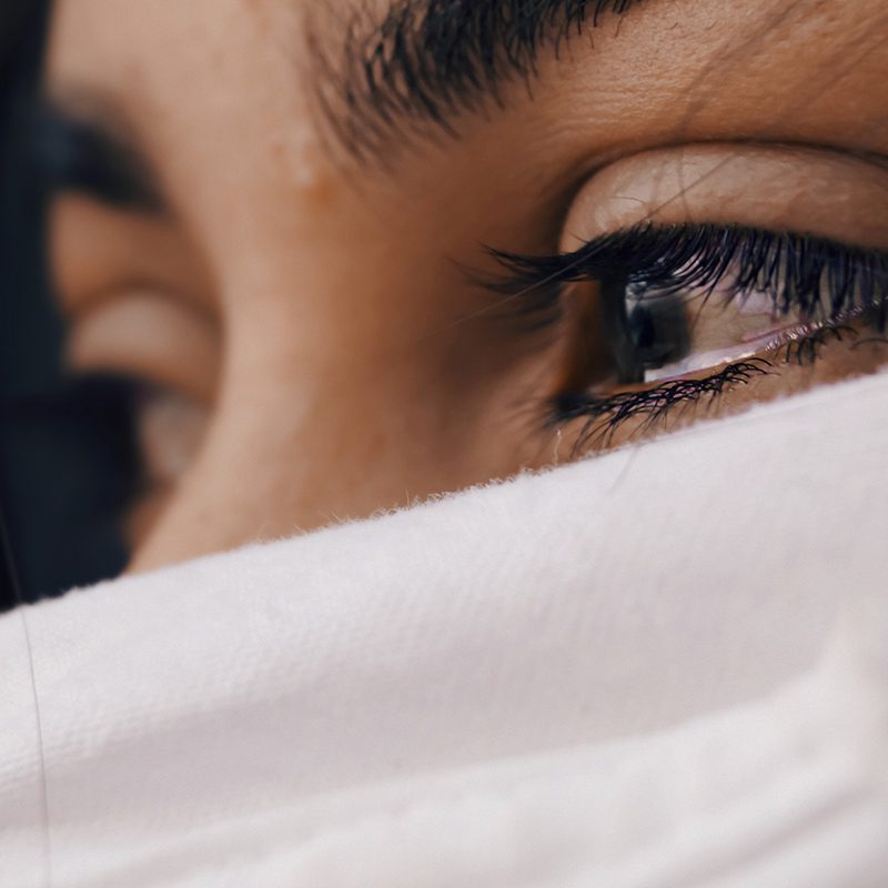 woman with kleenex wiping tears